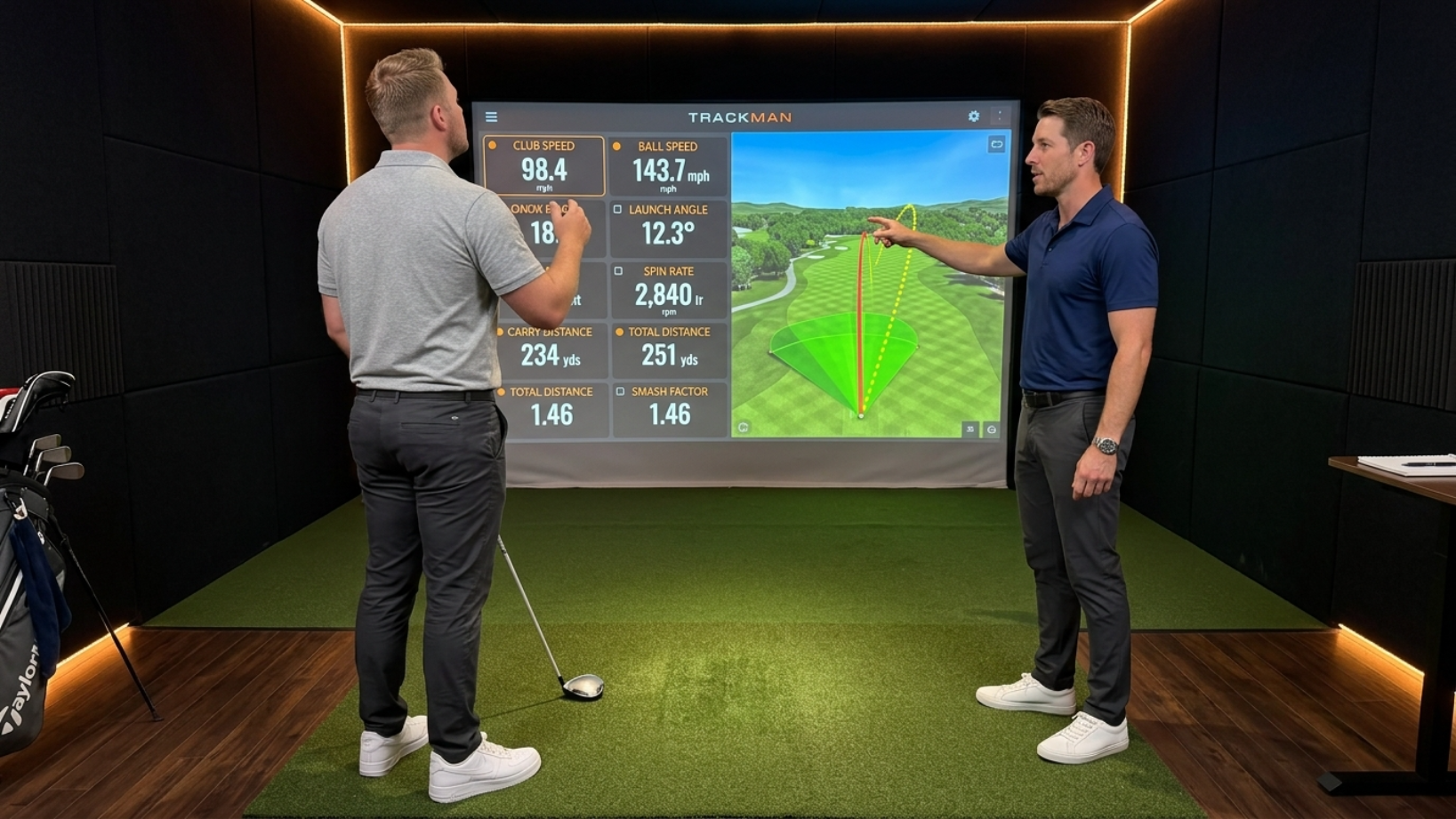 Golf coach instructing client inside premium simulator bay